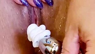 Shaved wet pussy glistens in shower with ass plug