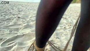 Shibari at sunset with Lari, her small tits and pussy exposed in the ropes.