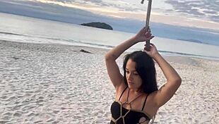 Shibari at sunset with Lari, her small tits and pussy exposed in the ropes.