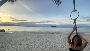 Shibari at sunset with Lari, her small tits and pussy exposed in the ropes.