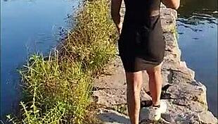 The prostitute enjoys a hot fuck in the river, getting pounded hard by a client in the water.