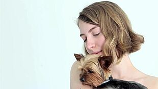 hot naked blonde cuddles her puppy in a tender moment