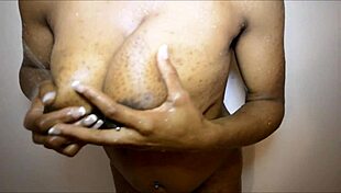 In the shower, she bathes under the warm water, enjoying the relaxing flow.