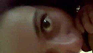 The purple haired girl eagerly sucks his cock in the room.