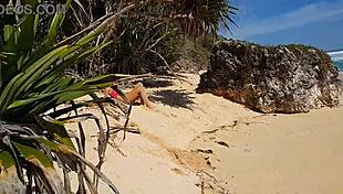 Sandy ass flaunting red butt plug at paradise beach