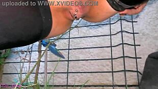 Milf La Gourmande pisses in leather skirt and stockings outdoors, caressing pierced clit after.