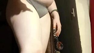 Busty camgirl in grey explores her curves