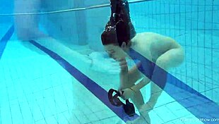 Red swimsuit beauty Katy shows off bushy pussy underwater in pool