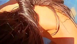 Beautiful couple shares close-up outdoor moment by the pool