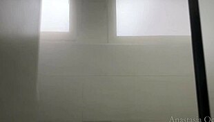 Watch her undress and shave in the shower, touching herself.