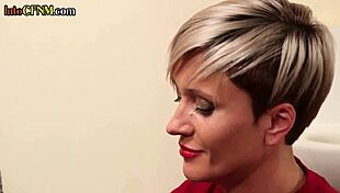 In the toilet, a busty tattooed milf jerks off a hard cock while talking dirty in a cfnm amateur scene