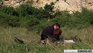 Old granny fucks passionately in the nature with a young man