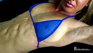 Muscular bodybuilder dances in bikini and thong