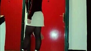 Leather catsuit clings to her legs under the miniskirt