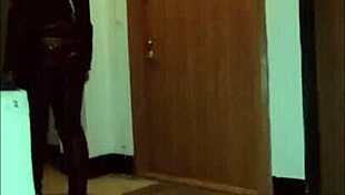 Leather catsuit clings to her legs under the miniskirt