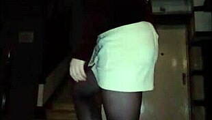 Leather catsuit clings to her legs under the miniskirt