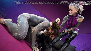 Heavy tattooed sub gets pegged by two dominas