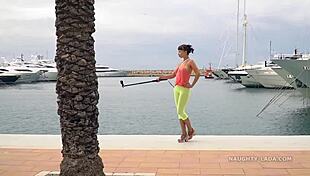 Camel-toe flashing in public with milf showing off tits and leggings in outdoor nude scene.