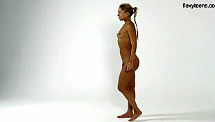 blonde teen flexy girl bends acrobatically in dress on sofa for yoga talents