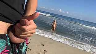 Jerking off on the beach while sexy girls join to help.