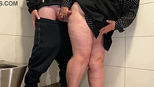 Juicy Milf Strokes Cock in Public Toilet