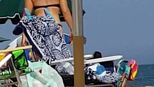 Check out this candid shot of the little slut's ass in bikini at the beach.