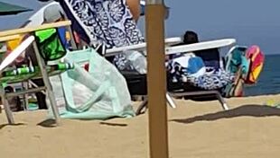 Check out this candid shot of the little slut's ass in bikini at the beach.