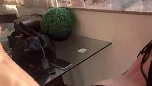 Couple performs in the building window for neighbors to watch.