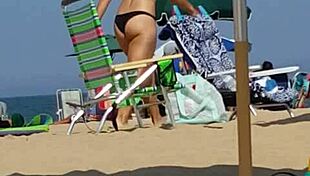 Check out this candid shot of the little slut's ass in bikini at the beach.