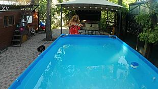 Melissa the mermaid swims in the pool with tattoos and brown eyes