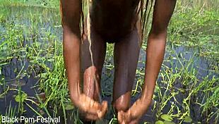 slim african woman bathing in river