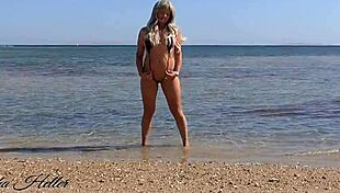 Beautiful young German mom shows off her big tits and ass in an extreme bikini in public.