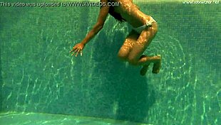Irina russaka bathes underwater in the pool as a petite shaved teen