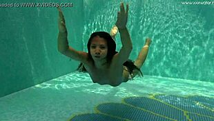 Irina russaka bathes underwater in the pool as a petite shaved teen