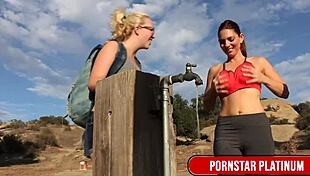 Samantha Rone tends to Mindi Mink's bushy pussy outdoors