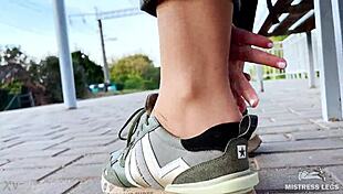 Tan nylon soles in blue jeans teasing on the bench