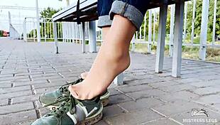 Tan nylon soles in blue jeans teasing on the bench