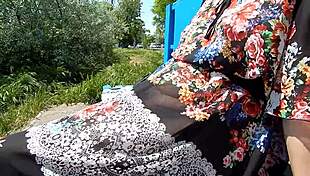 hairy mature woman flashes her chubby body in a see-through dress outdoors