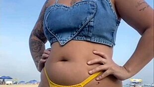 African woman flashes on beach.