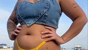 African woman flashes on beach.