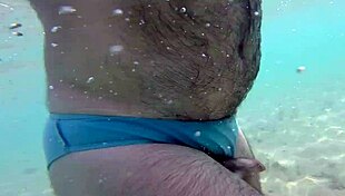 Uncle relaxes naked on the sunny beach