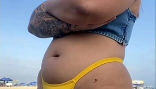 African woman flashes on beach.