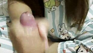 this cute asian girl surprises her boyfriend with a slow teasing handjob in their cozy bedroom
