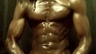 Have you seen this muscular bodybuilder stroking his big black cock with oil?