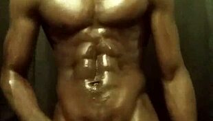 Have you seen this muscular bodybuilder stroking his big black cock with oil?