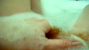 annie relaxes in the bath, fingering her hairy pussy