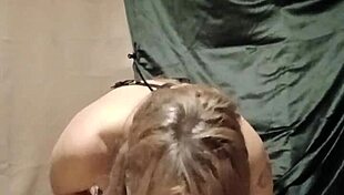 slave self-bondage with harness and magic wand