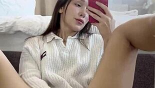 Ellie Leen fingers her hairless shaved pussy in front of the mirror