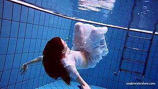 redhead marketa in a white dress in the pool