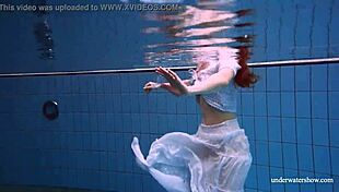 redhead marketa in a white dress in the pool